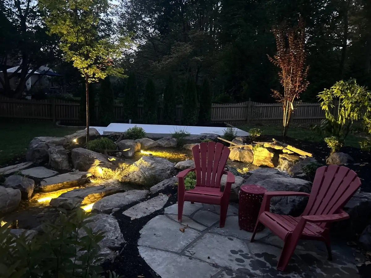 Illuminated stone and water feature at night