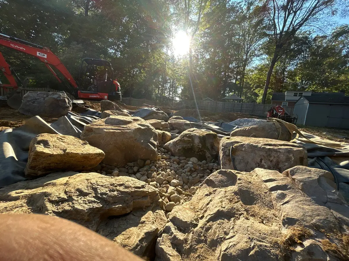 Pond build with natural boulder layout