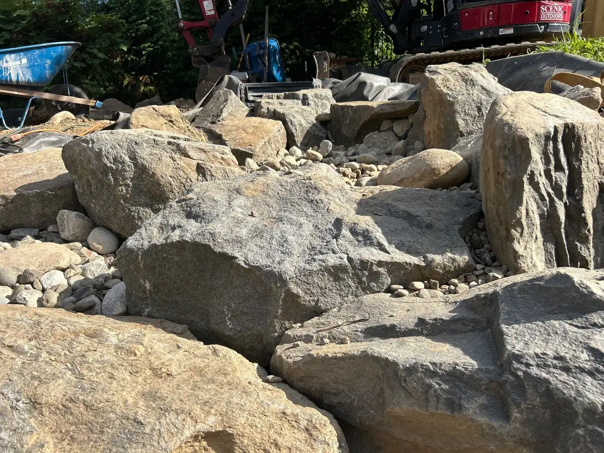 Pond maintenance professional checking a backyard water feature