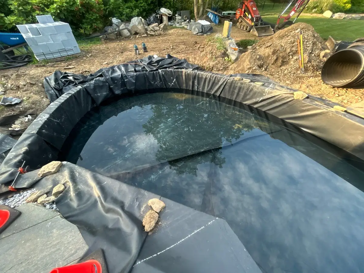 Backyard waterfall flowing into a pond